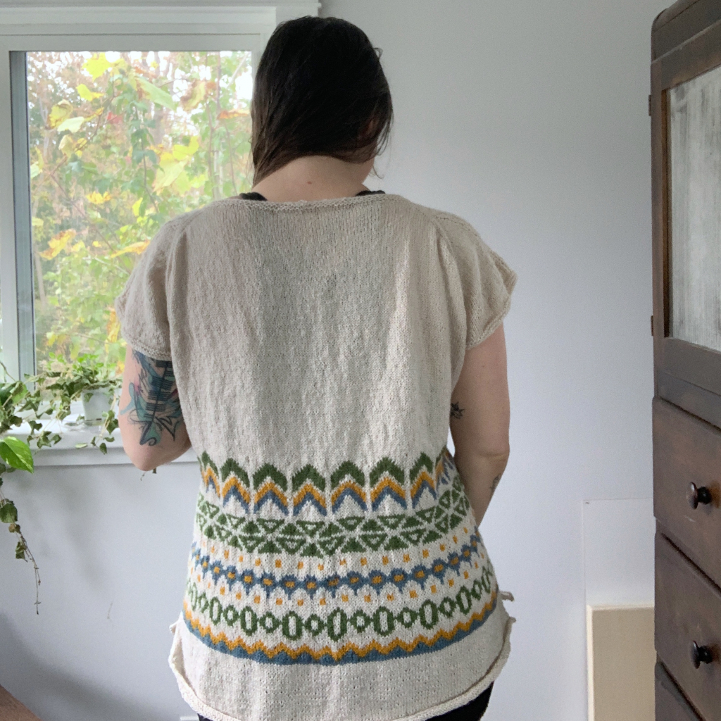 Back view of the maker modelling the pattern test of the Minerva Tee
